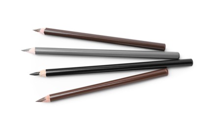 Photo of Different eyebrow pencils isolated on white, top view