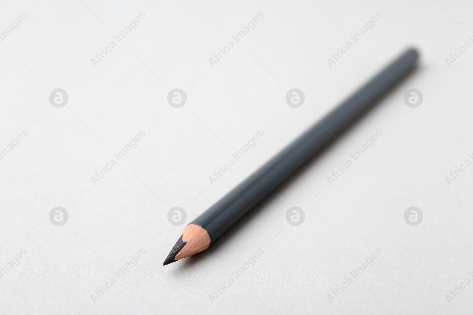 Grey eyebrow pencil on light background, closeup. Space for text Photo of Grey eyebrow pencil on light background, closeup. Space for text