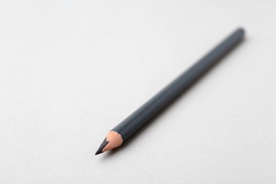 Photo of Grey eyebrow pencil on light background, closeup. Space for text