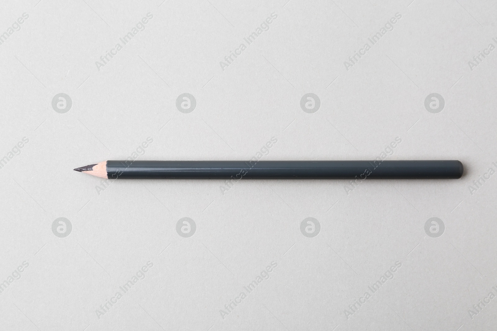 Grey eyebrow pencil on light background, top view Photo of Grey eyebrow pencil on light background, top view