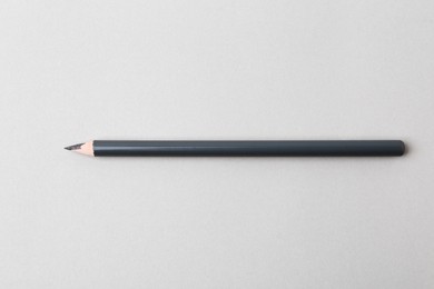 Photo of Grey eyebrow pencil on light background, top view
