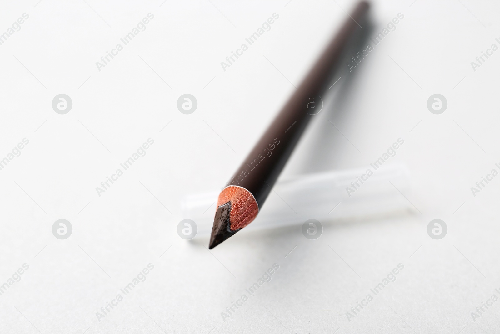 Brown eyebrow pencil on light background, closeup Photo of Brown eyebrow pencil on light background, closeup