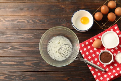 Photo of Making whipped cream. Bowl, whisk and ingredients on wooden table, flat lay. Space for text
