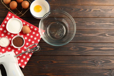 Photo of Making whipped cream. Bowl, whisk and ingredients on wooden table, flat lay. Space for text