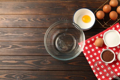 Photo of Making whipped cream. Bowl, whisk and ingredients on wooden table, flat lay. Space for text