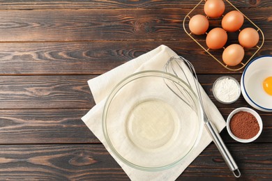 Photo of Making whipped cream. Bowl, whisk and ingredients on wooden table, flat lay. Space for text