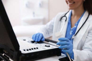 Photo of Professional sonographer with ultrasound machine in clinic, closeup