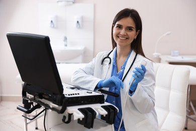 Photo of Professional sonographer with ultrasound machine in clinic