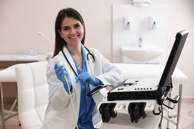 Photo of Professional sonographer with ultrasound machine in clinic