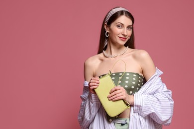 Photo of Fashionable portrait of beautiful woman in stylish outfit on pink background. Space for text