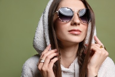 Photo of Woman in stylish outfit on green background