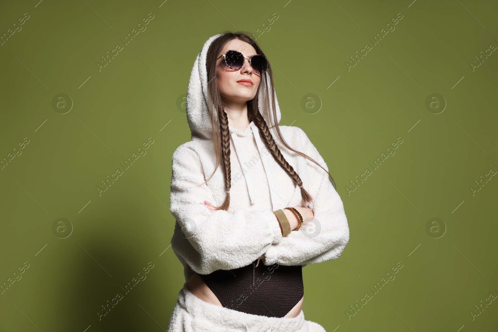 Fashionable portrait of beautiful woman in stylish outfit on green background Photo of Fashionable portrait of beautiful woman in stylish outfit on green background
