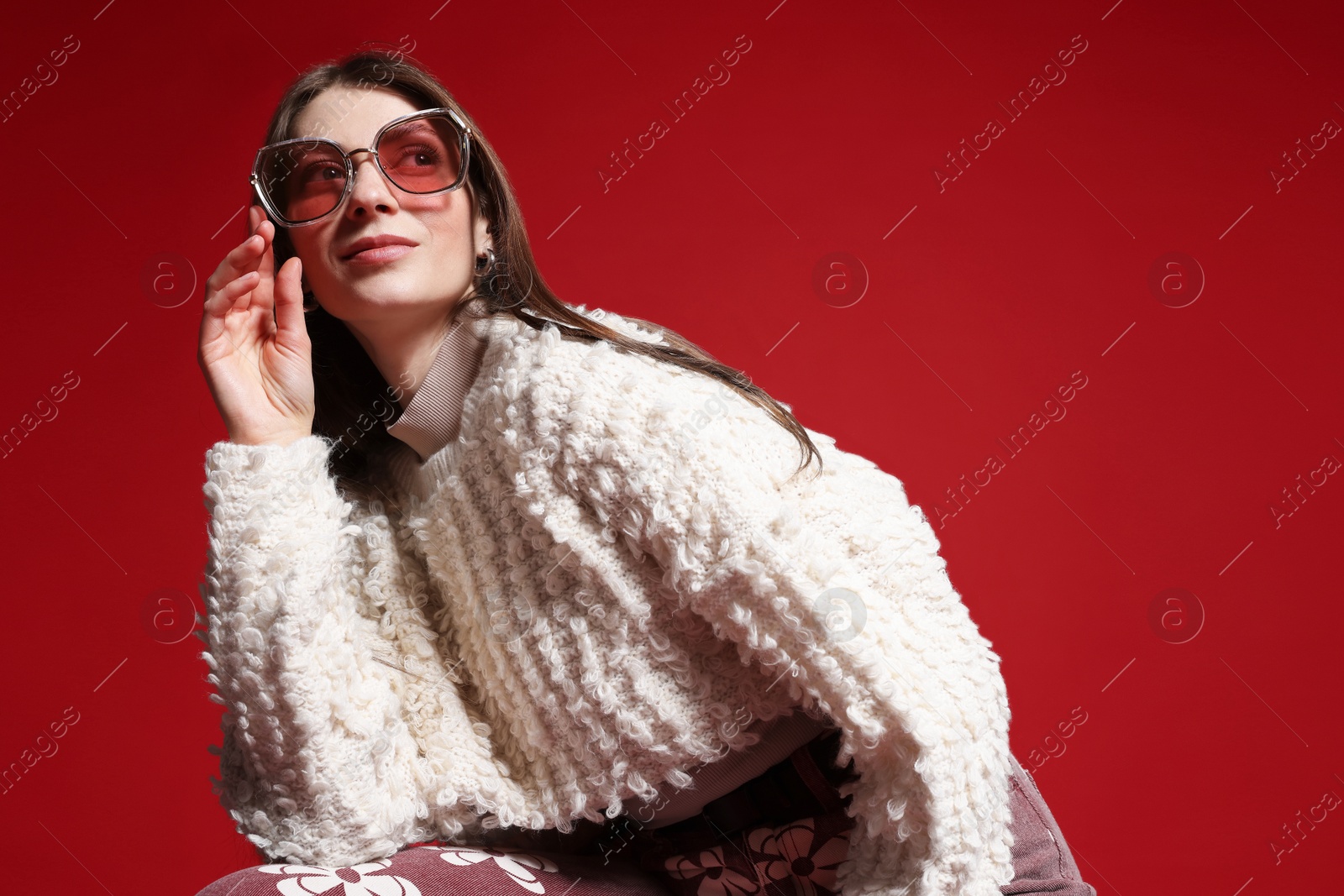 Fashionable portrait of beautiful woman in stylish outfit on red background. Space for text Photo of Fashionable portrait of beautiful woman in stylish outfit on red background. Space for text