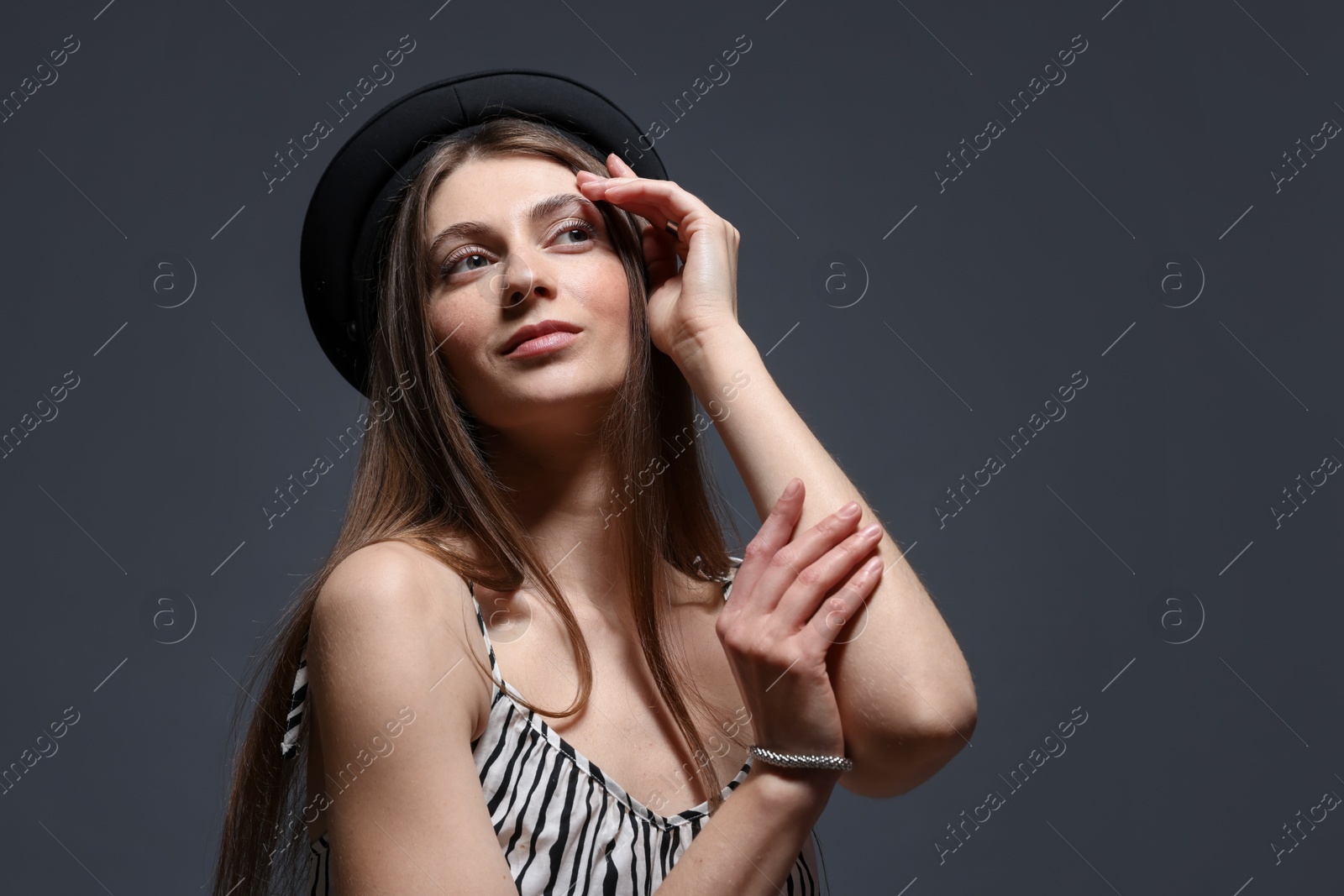 Fashionable portrait of beautiful woman in stylish outfit on grey background. Space for text Photo of Fashionable portrait of beautiful woman in stylish outfit on grey background. Space for text