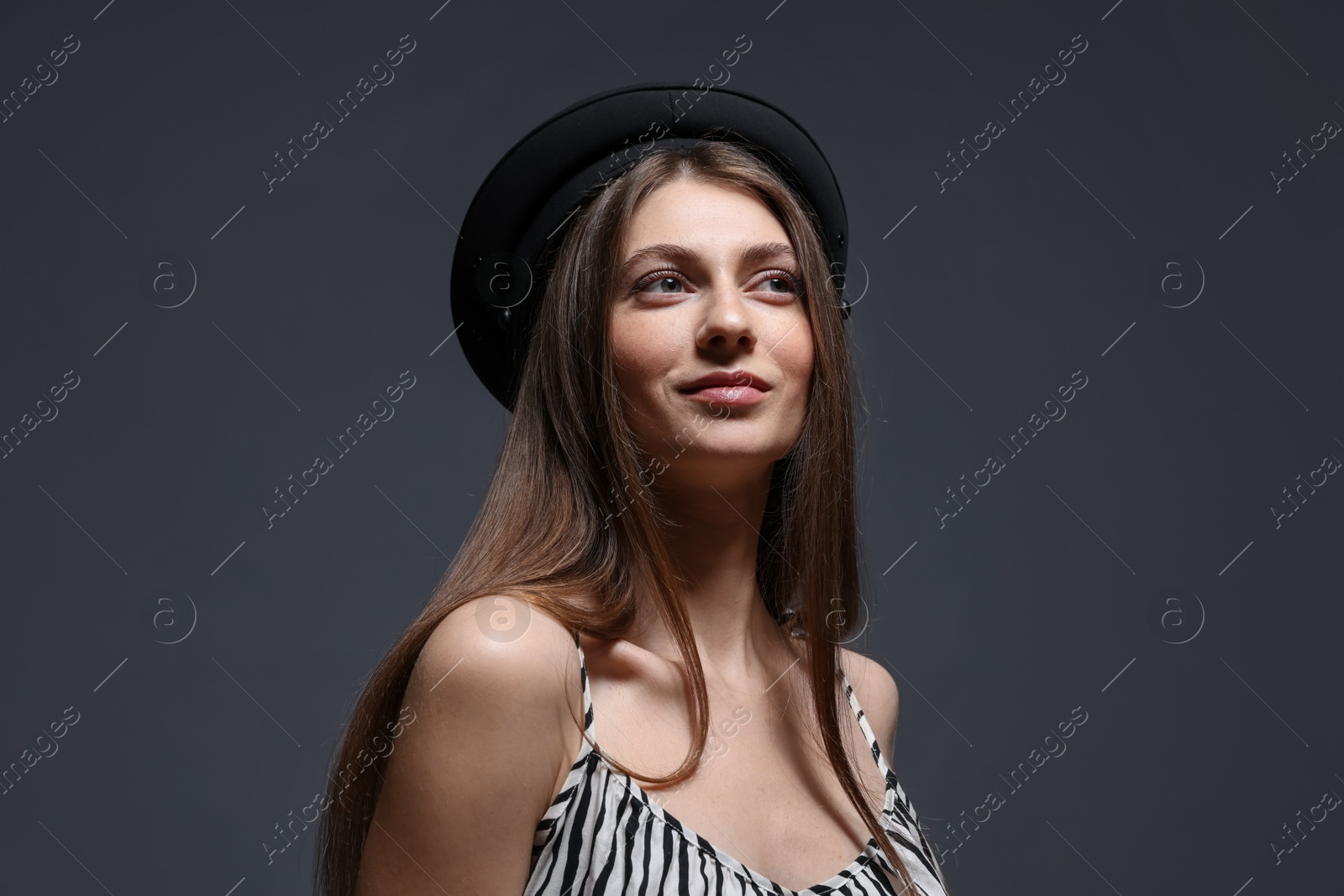 Fashionable portrait of beautiful woman in stylish outfit on grey background Photo of Fashionable portrait of beautiful woman in stylish outfit on grey background