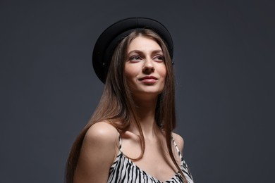 Photo of Fashionable portrait of beautiful woman in stylish outfit on grey background