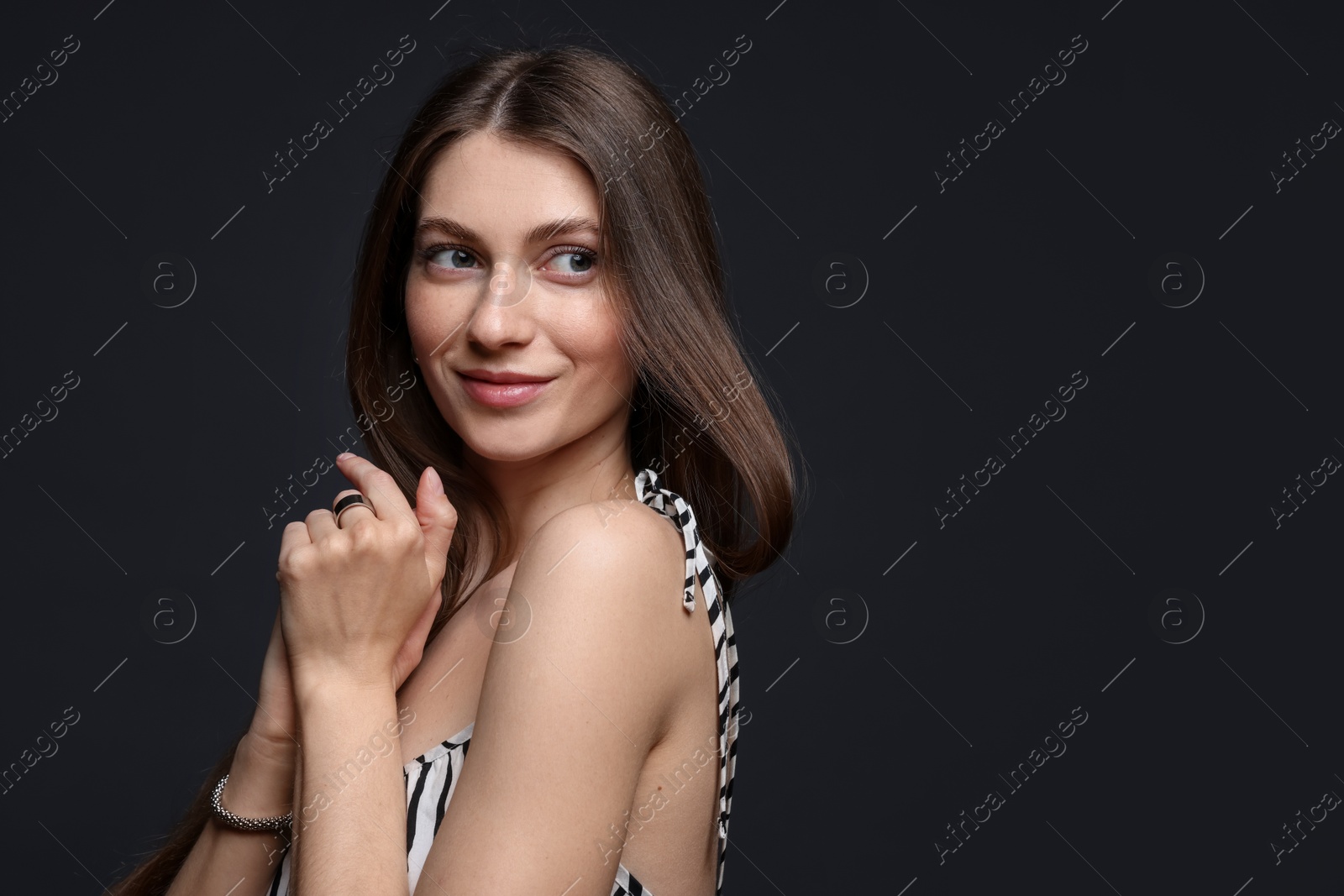 Fashionable portrait of beautiful woman in stylish outfit on grey background. Space for text Photo of Fashionable portrait of beautiful woman in stylish outfit on grey background. Space for text