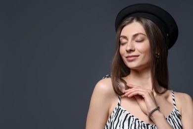 Photo of Fashionable portrait of beautiful woman in stylish outfit on grey background. Space for text