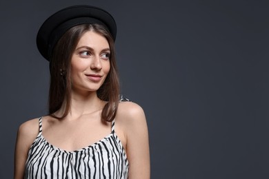 Photo of Fashionable portrait of beautiful woman in stylish outfit on grey background. Space for text