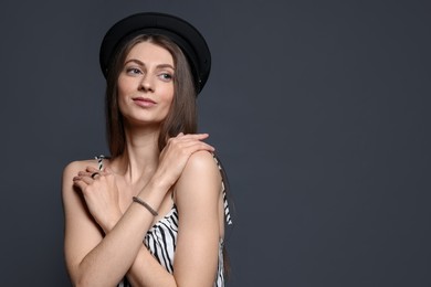 Photo of Fashionable portrait of beautiful woman in stylish outfit on grey background. Space for text