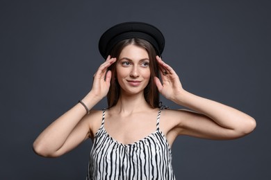 Photo of Fashionable portrait of beautiful woman in stylish outfit on grey background