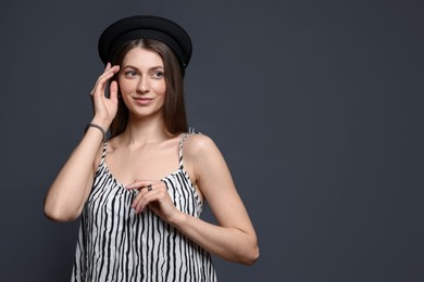 Photo of Fashionable portrait of beautiful woman in stylish outfit on grey background. Space for text