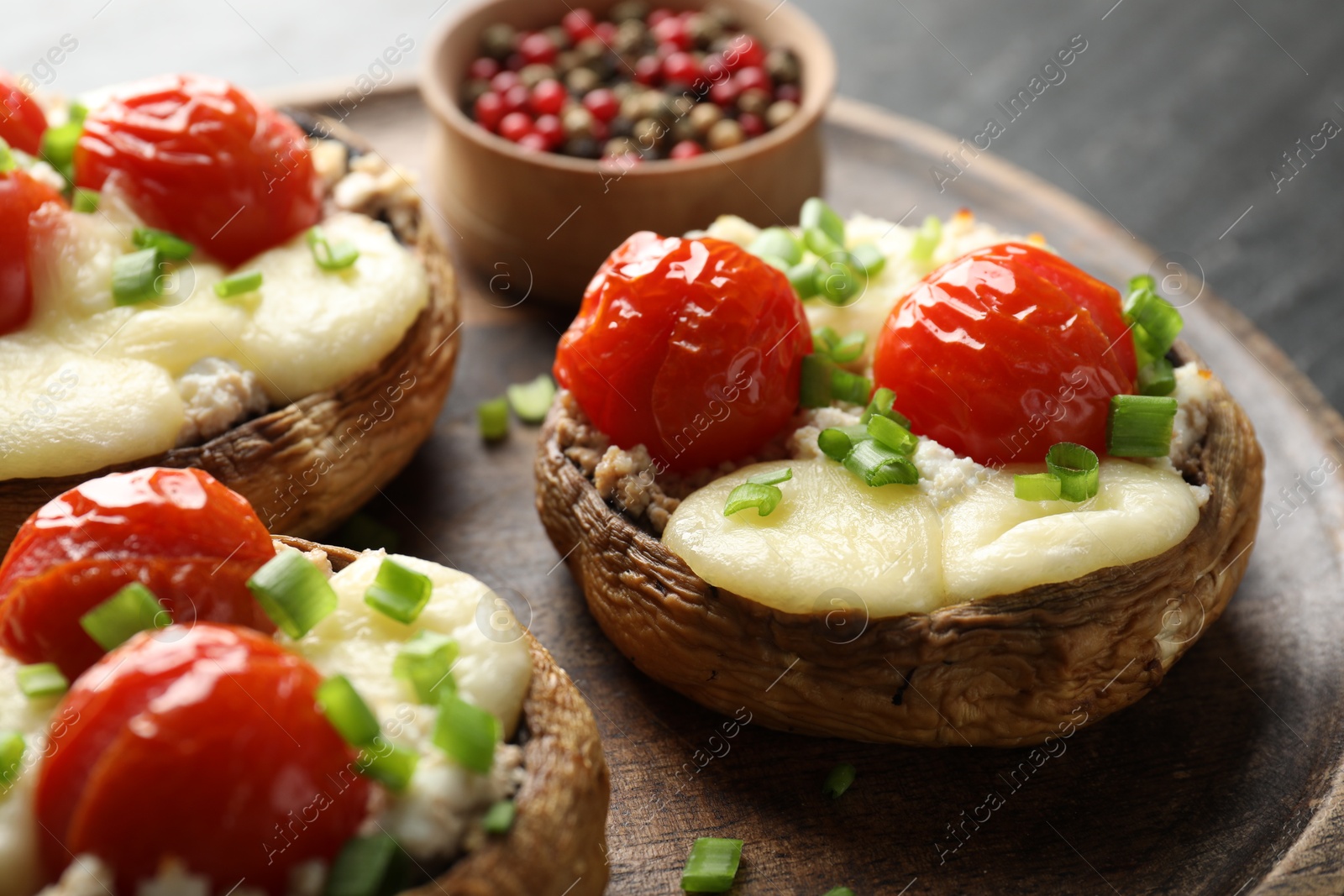 Tasty stuffed mushrooms served on black table, closeup Photo of Tasty stuffed mushrooms served on black table, closeup