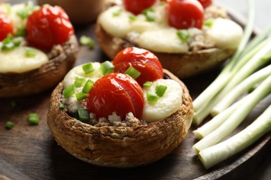 Photo of Tasty stuffed mushrooms served on table, closeup