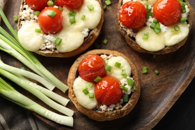 Photo of Tasty stuffed mushrooms served on table, top view