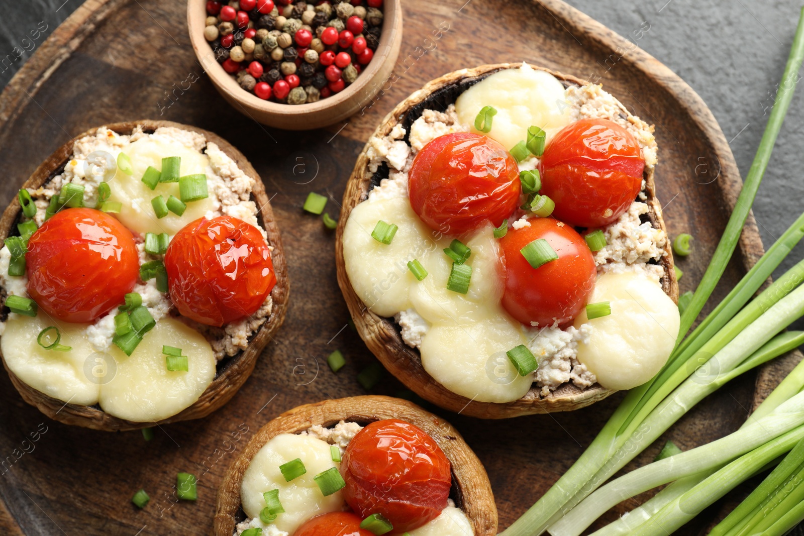 Tasty stuffed mushrooms served on black table, top view Photo of Tasty stuffed mushrooms served on black table, top view
