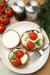Photo of Tasty stuffed mushrooms served on light table, flat lay