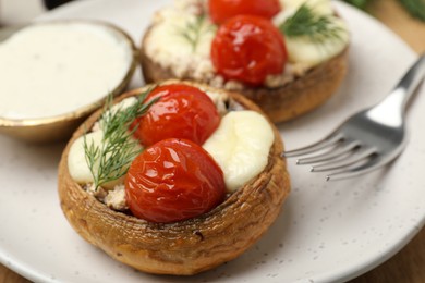 Photo of Tasty stuffed mushrooms served on table, closeup