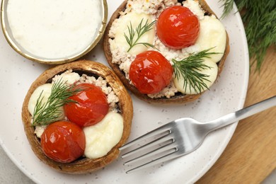 Photo of Tasty stuffed mushrooms served on table, top view