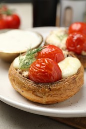 Photo of Tasty stuffed mushrooms served on table, closeup
