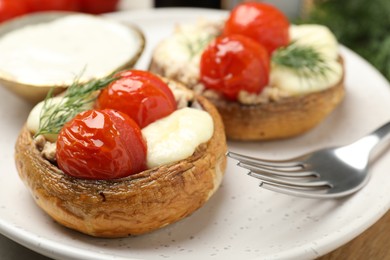 Photo of Tasty stuffed mushrooms served on table, closeup