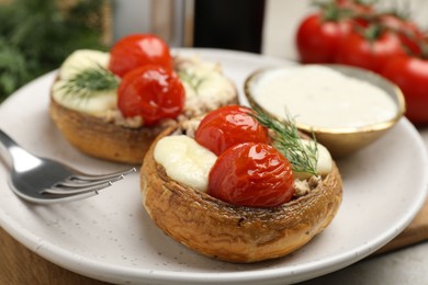 Photo of Tasty stuffed mushrooms served on table, closeup