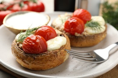 Photo of Tasty stuffed mushrooms served on table, closeup