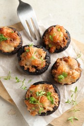 Photo of Tasty stuffed mushrooms served on light table, top view