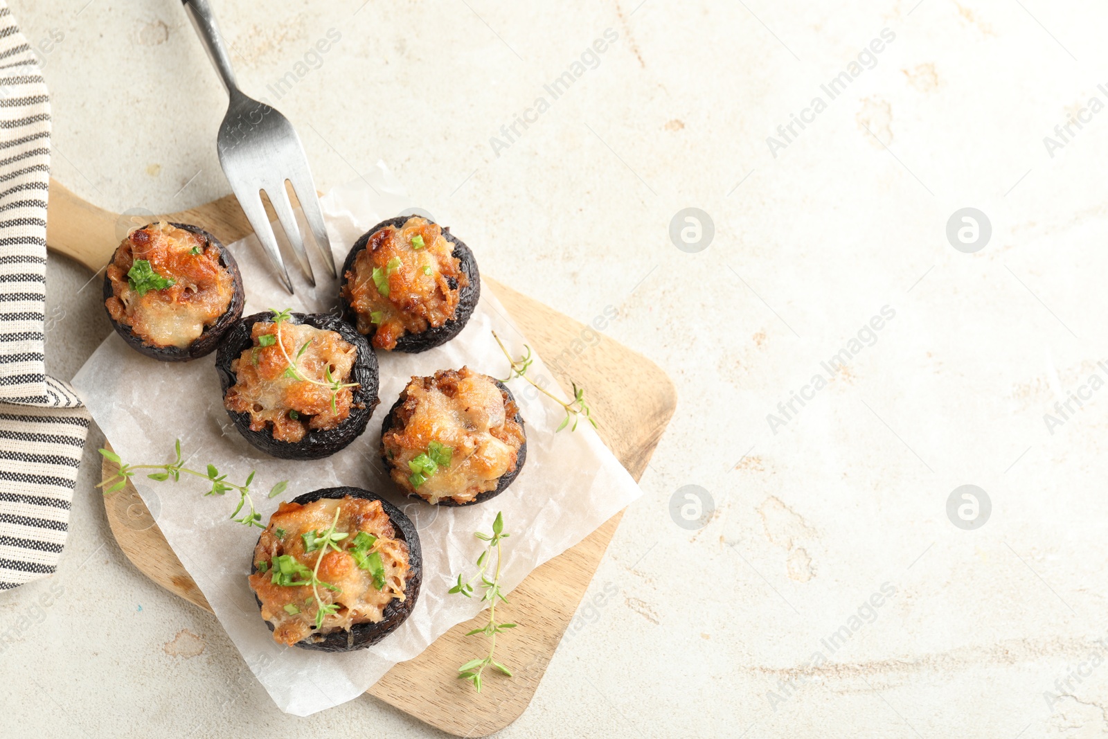 Tasty stuffed mushrooms served on light table, top view. Space for text Photo of Tasty stuffed mushrooms served on light table, top view. Space for text
