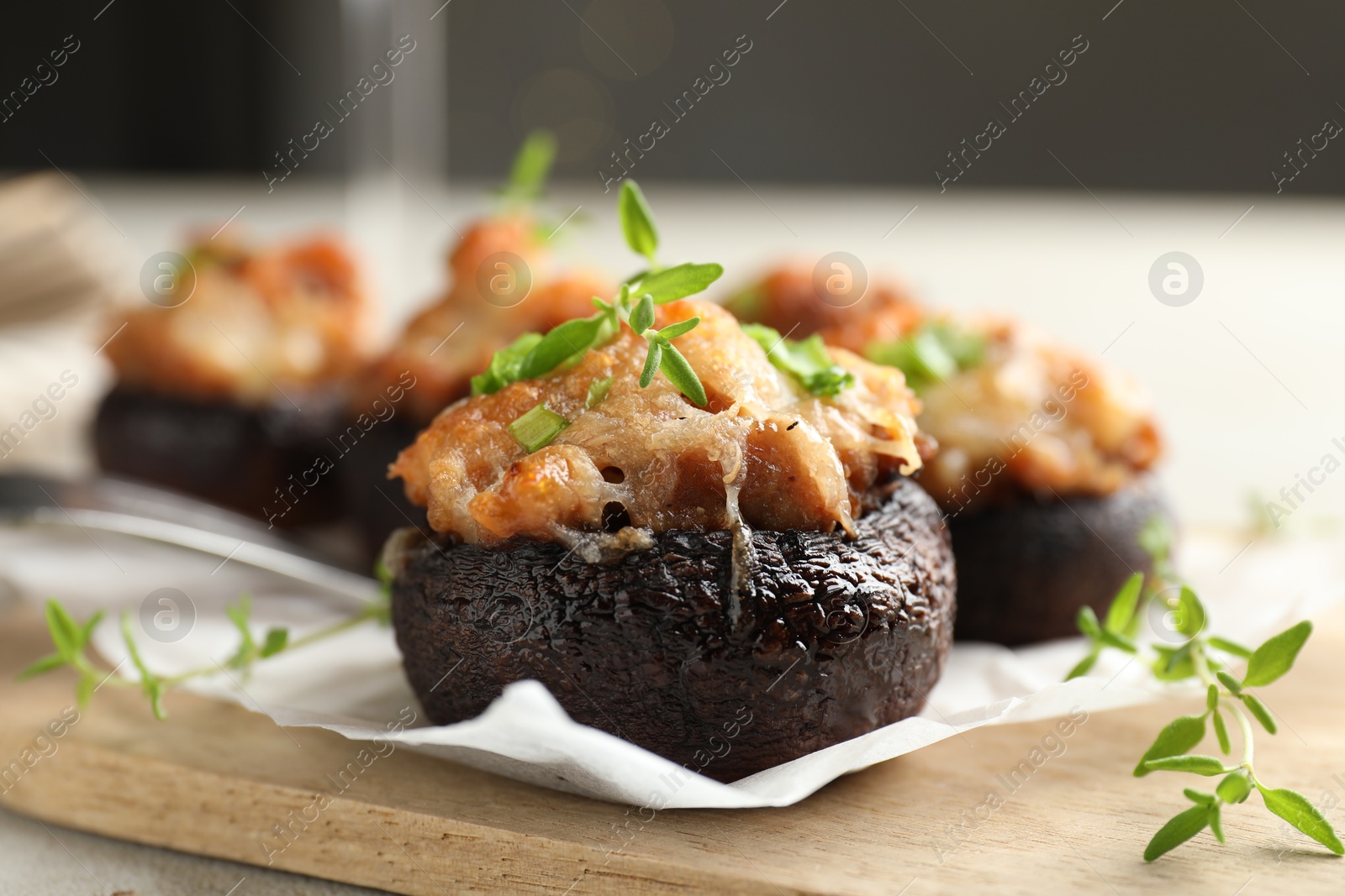 Tasty stuffed mushrooms served on light table against blurred background, closeup Photo of Tasty stuffed mushrooms served on light table against blurred background, closeup