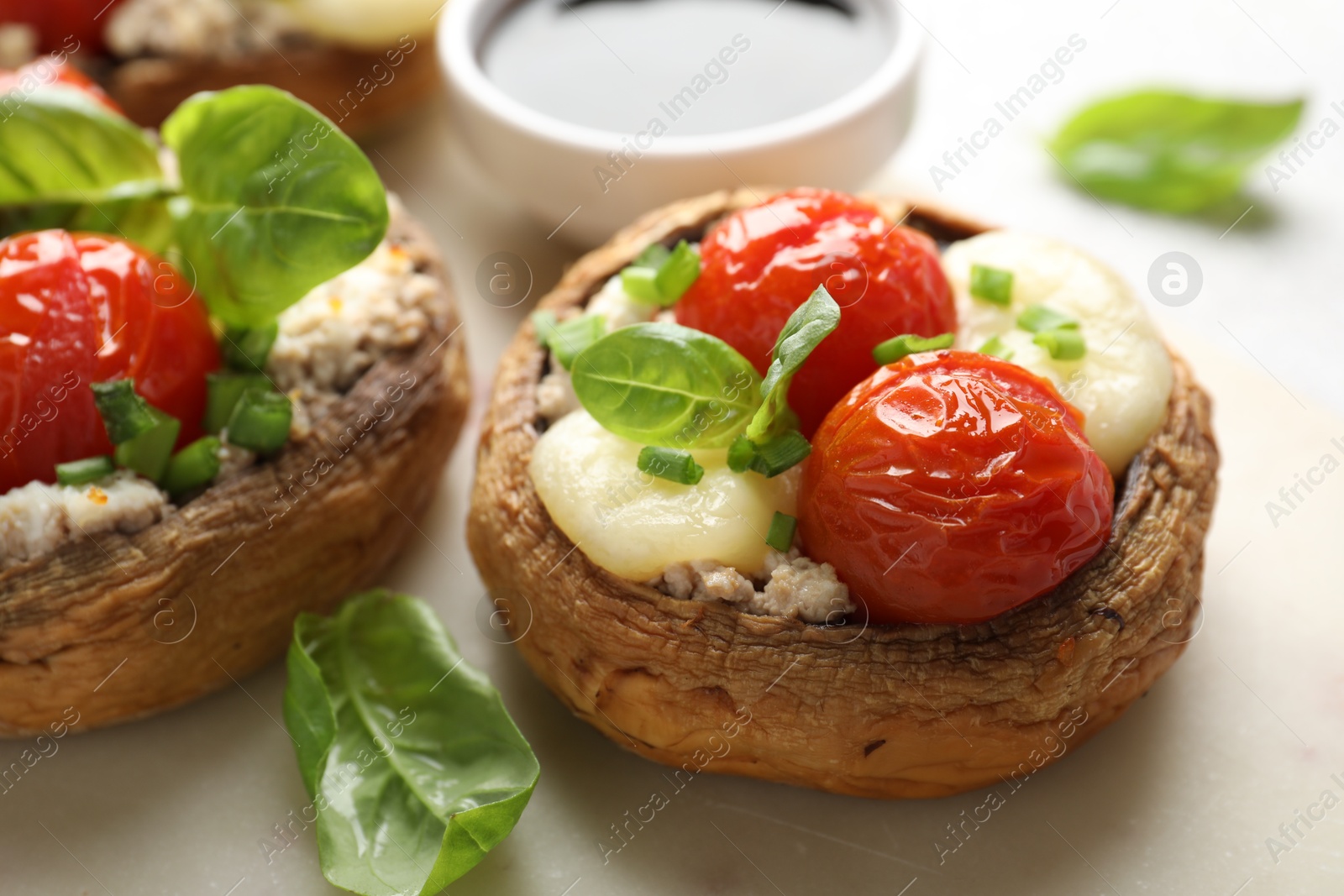 Tasty stuffed mushrooms served on light table, closeup Photo of Tasty stuffed mushrooms served on light table, closeup