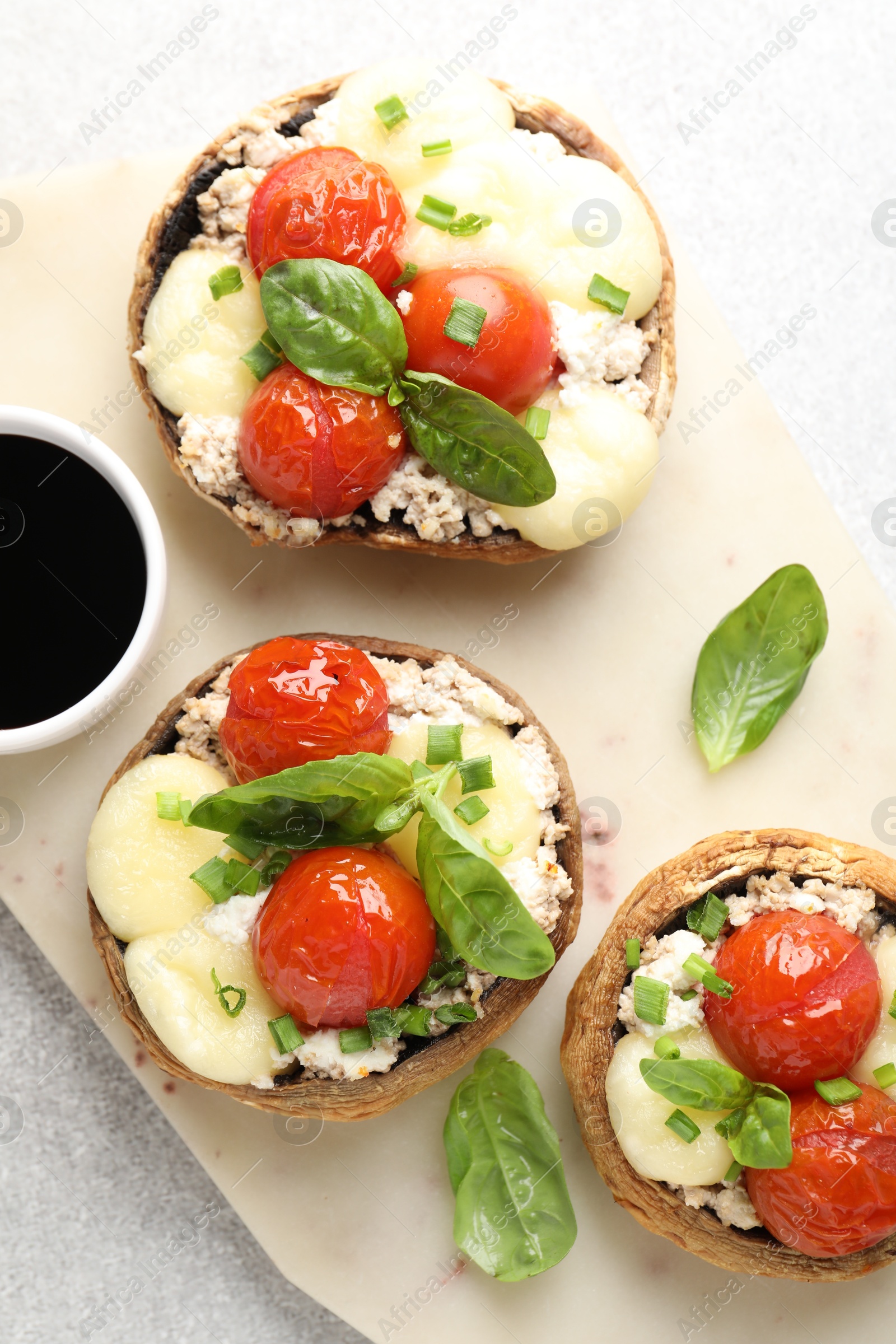 Tasty stuffed mushrooms served on light table, top view Photo of Tasty stuffed mushrooms served on light table, top view