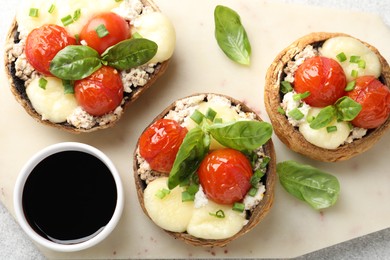 Photo of Tasty stuffed mushrooms served on light table, top view