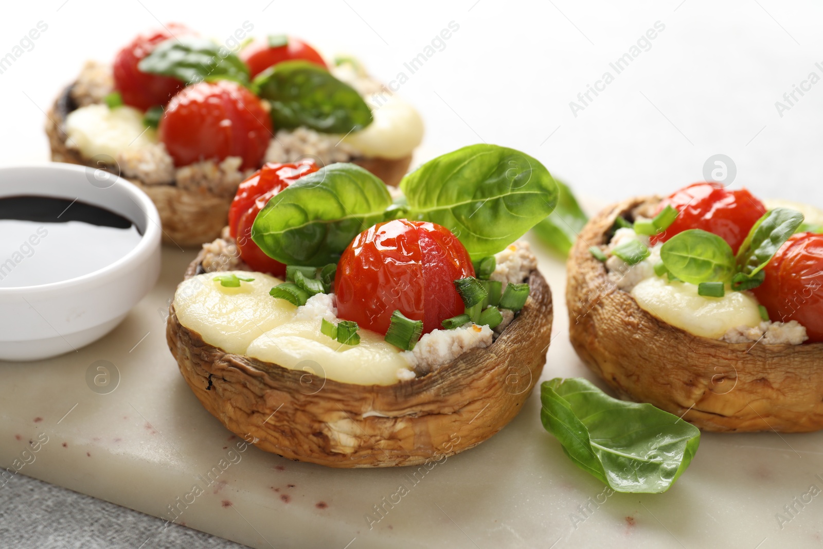 Tasty stuffed mushrooms served on light table, closeup Photo of Tasty stuffed mushrooms served on light table, closeup
