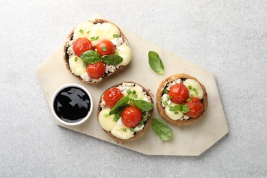Photo of Tasty stuffed mushrooms served on light table, top view