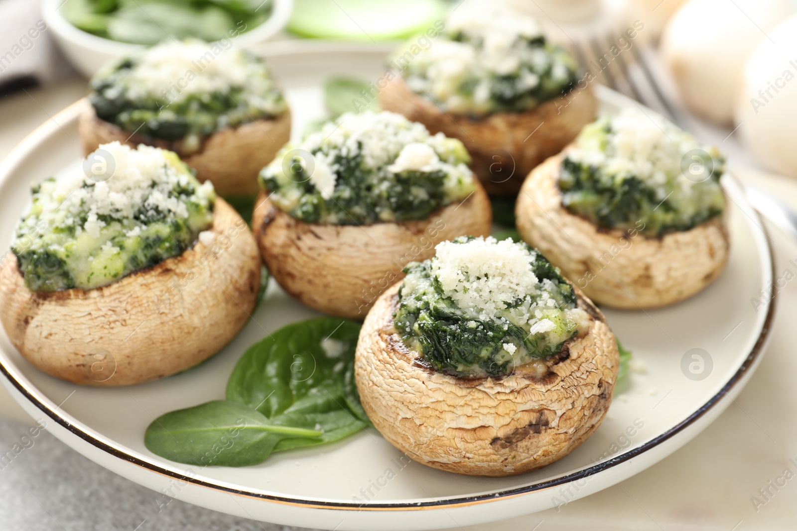 Tasty stuffed mushrooms served on light table, closeup Photo of Tasty stuffed mushrooms served on light table, closeup