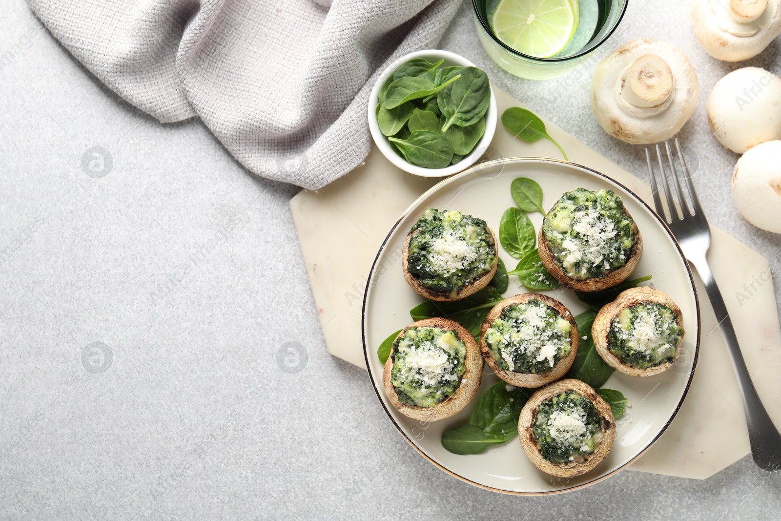 Tasty stuffed mushrooms served on light table, flat lay. Space for text Photo of Tasty stuffed mushrooms served on light table, flat lay. Space for text