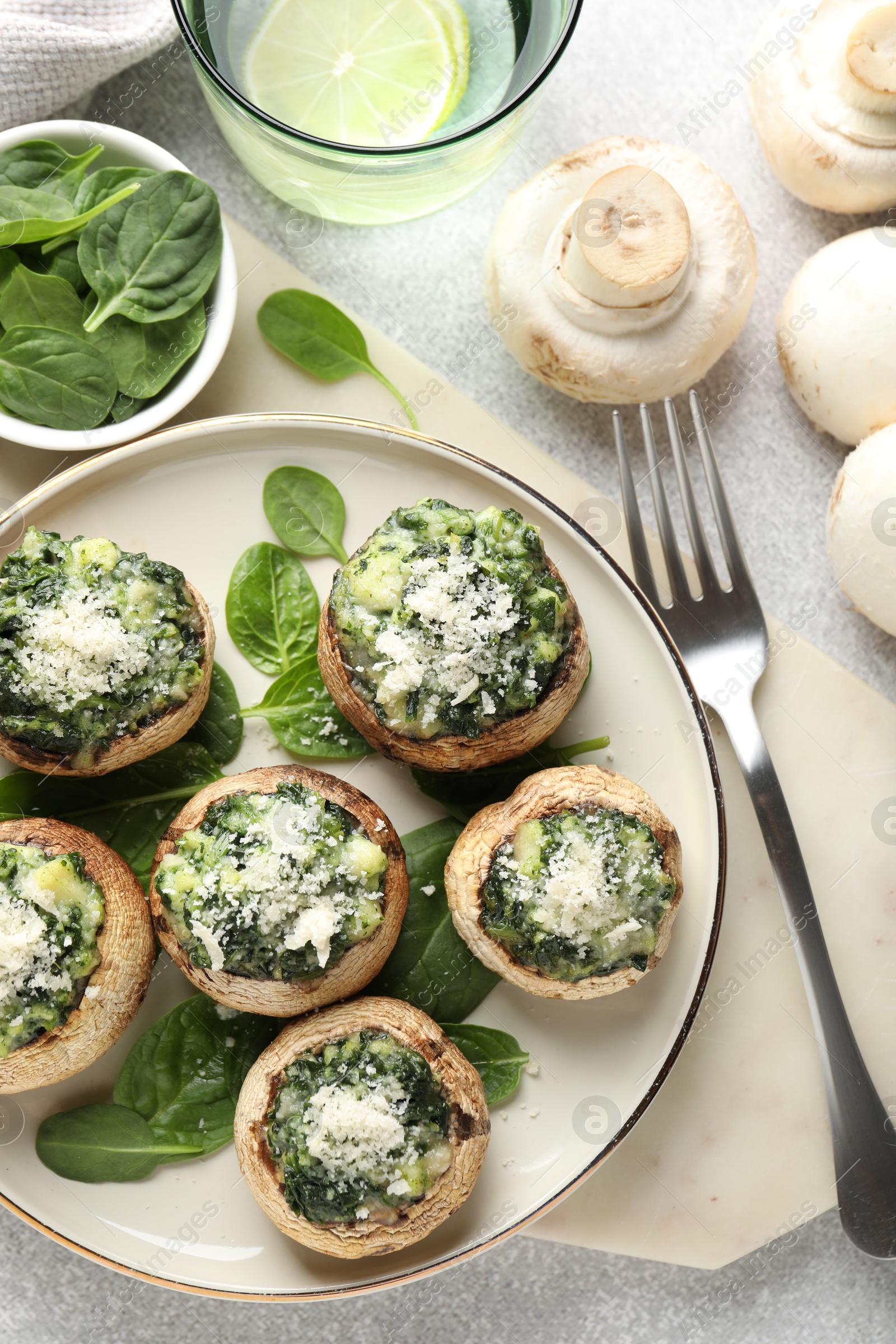 Tasty stuffed mushrooms served on light table, flat lay Photo of Tasty stuffed mushrooms served on light table, flat lay