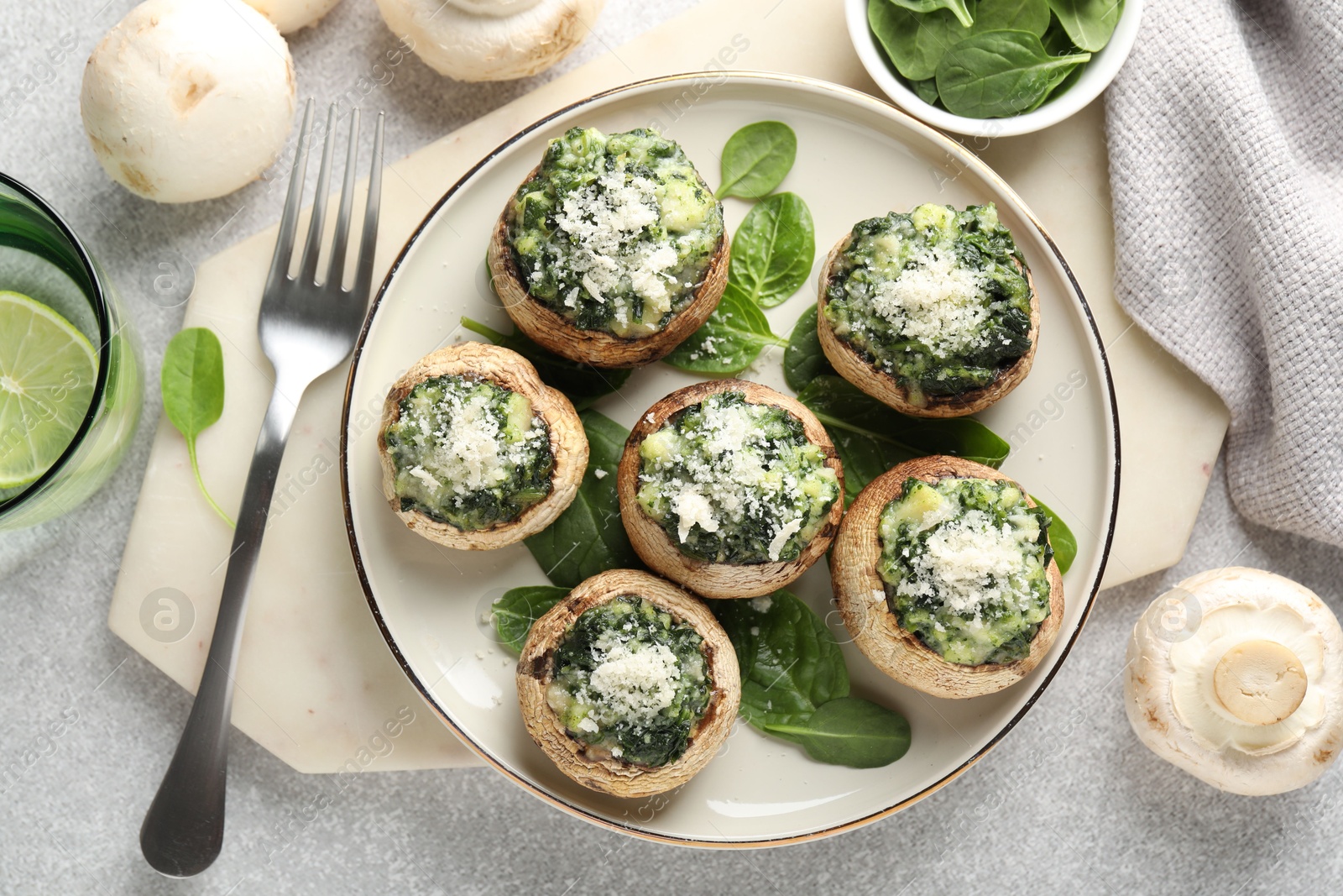 Tasty stuffed mushrooms served on light table, flat lay Photo of Tasty stuffed mushrooms served on light table, flat lay