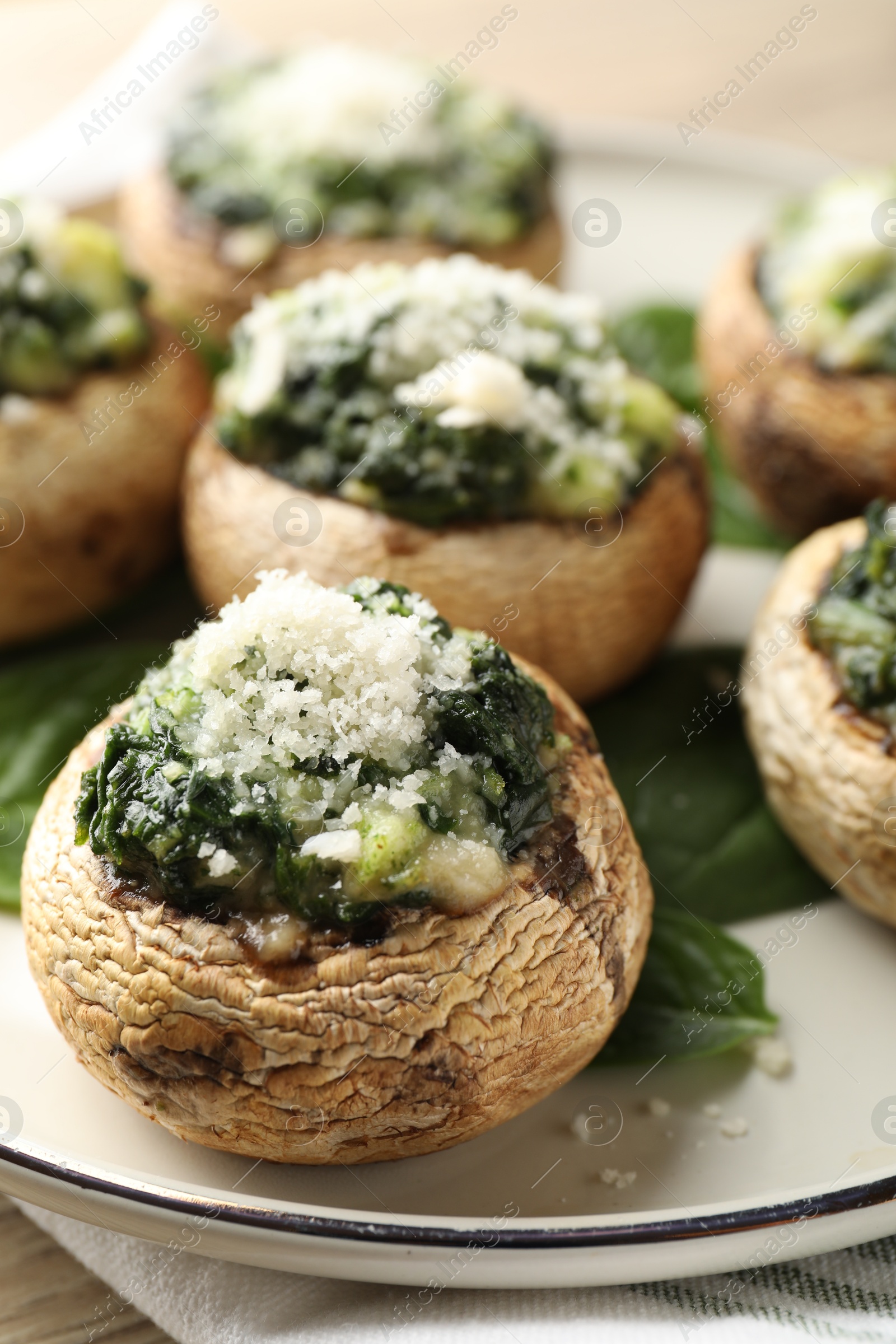 Tasty stuffed mushrooms served on table, closeup Photo of Tasty stuffed mushrooms served on table, closeup